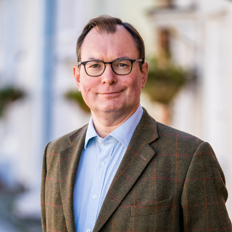 Paul Willans standing in the street near AJB Wealth's office in Alresford, Hampshire