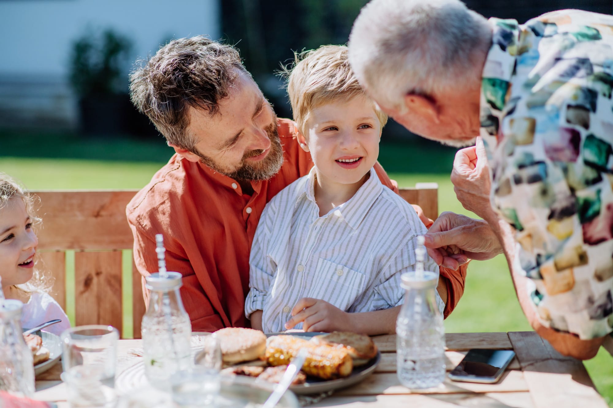 Planning for retirement: this happy scene shows father, son and grandfather at a barbecue
