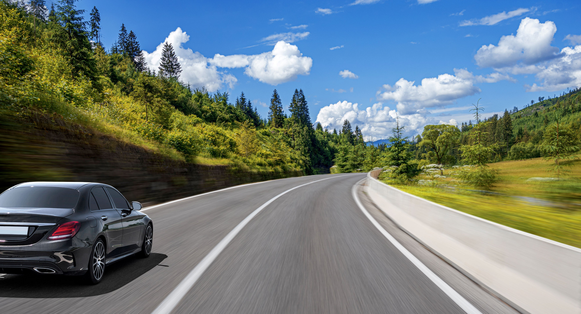 A smart looking car speeds through a beautiful landscape, in the way you might wish to steer your savings and investments
