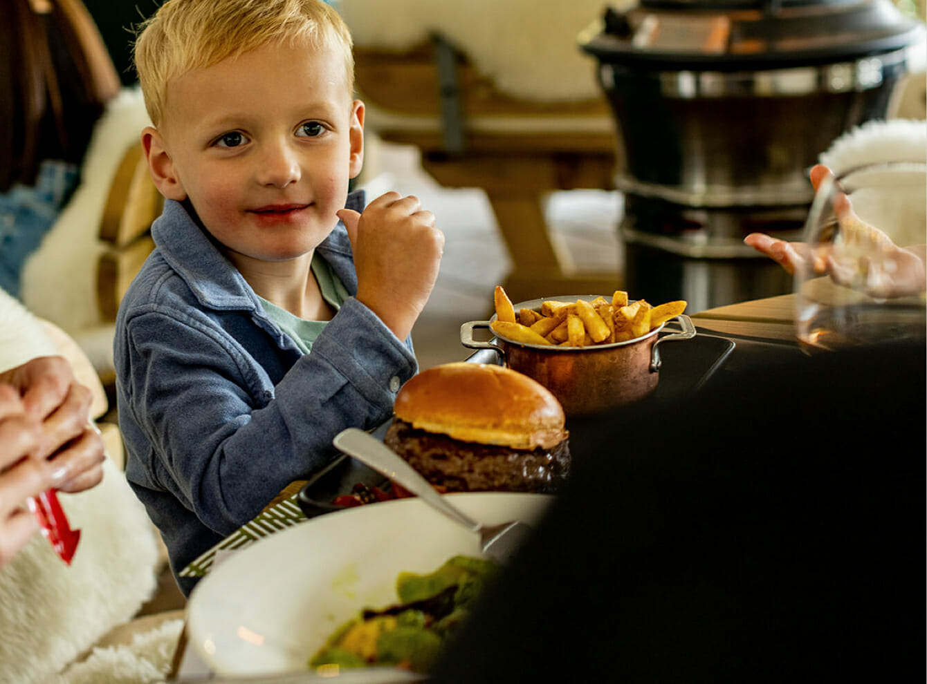 boy sitting with burger and chips
