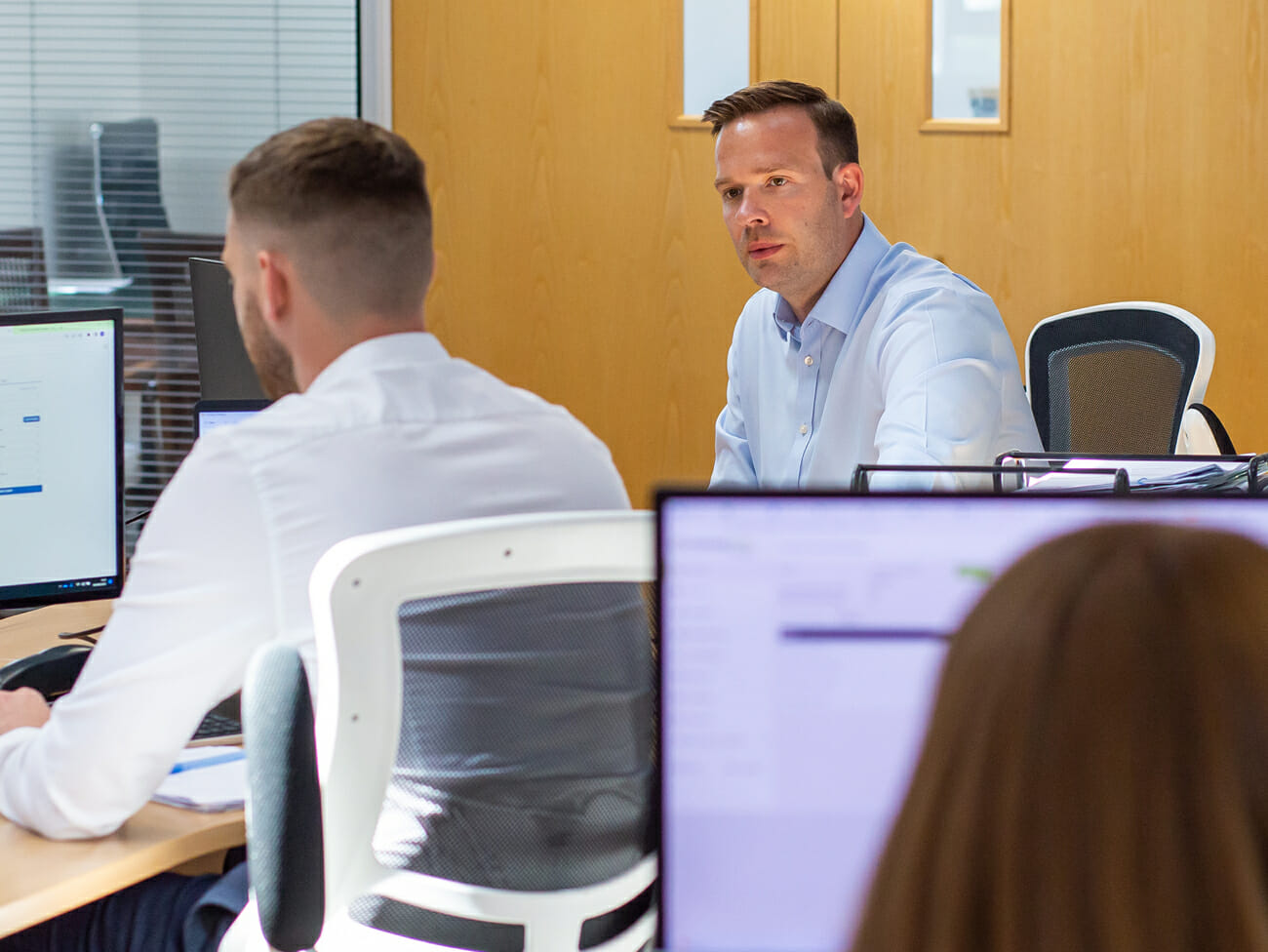 man talking to colleague at work