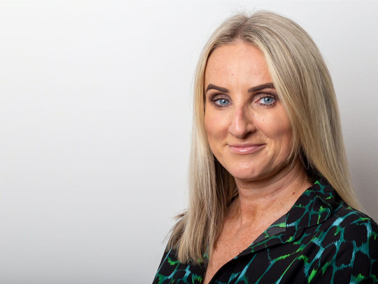 blonde woman smiling at camera